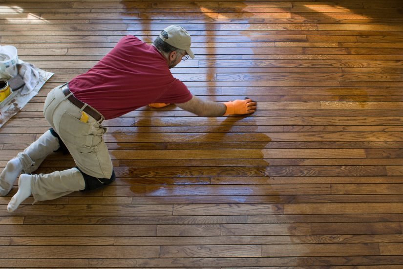 a man refinishing a wood floor in selma tx